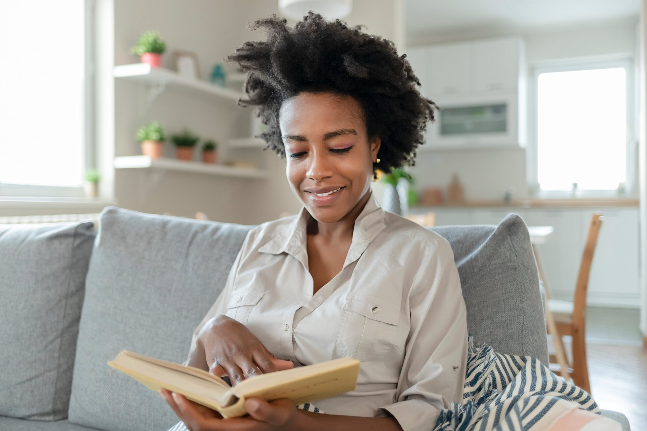 woman sitting on a sofa reading