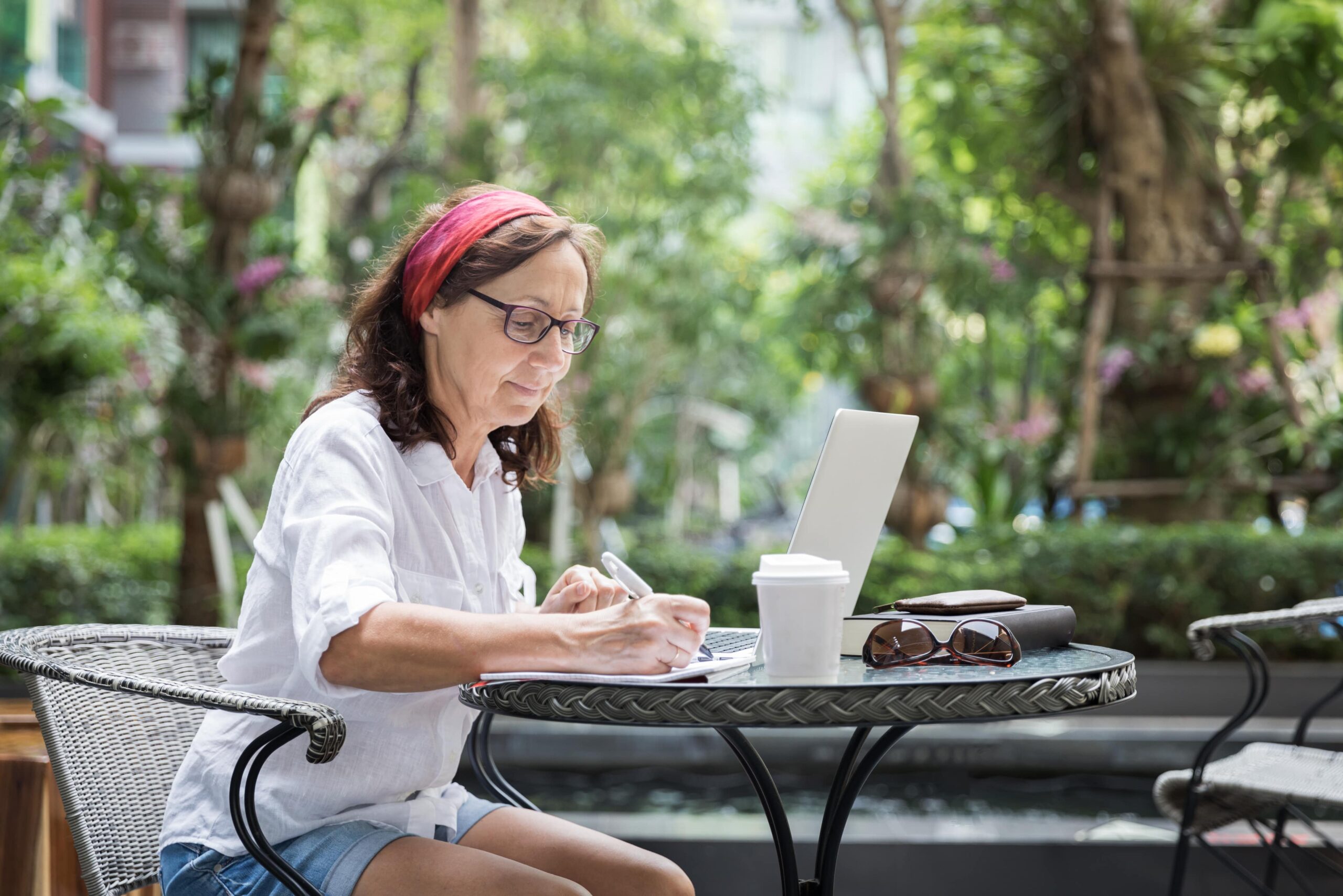 woman working on laptop outdoors in the garden