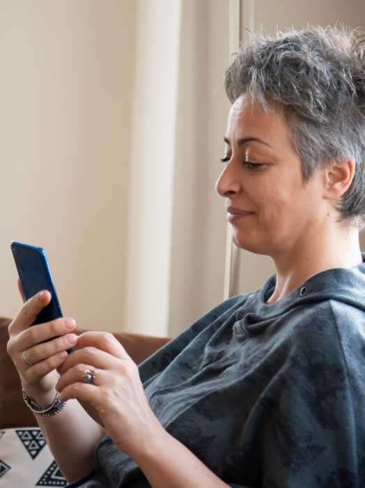 woman using mobile phone at home 1.png